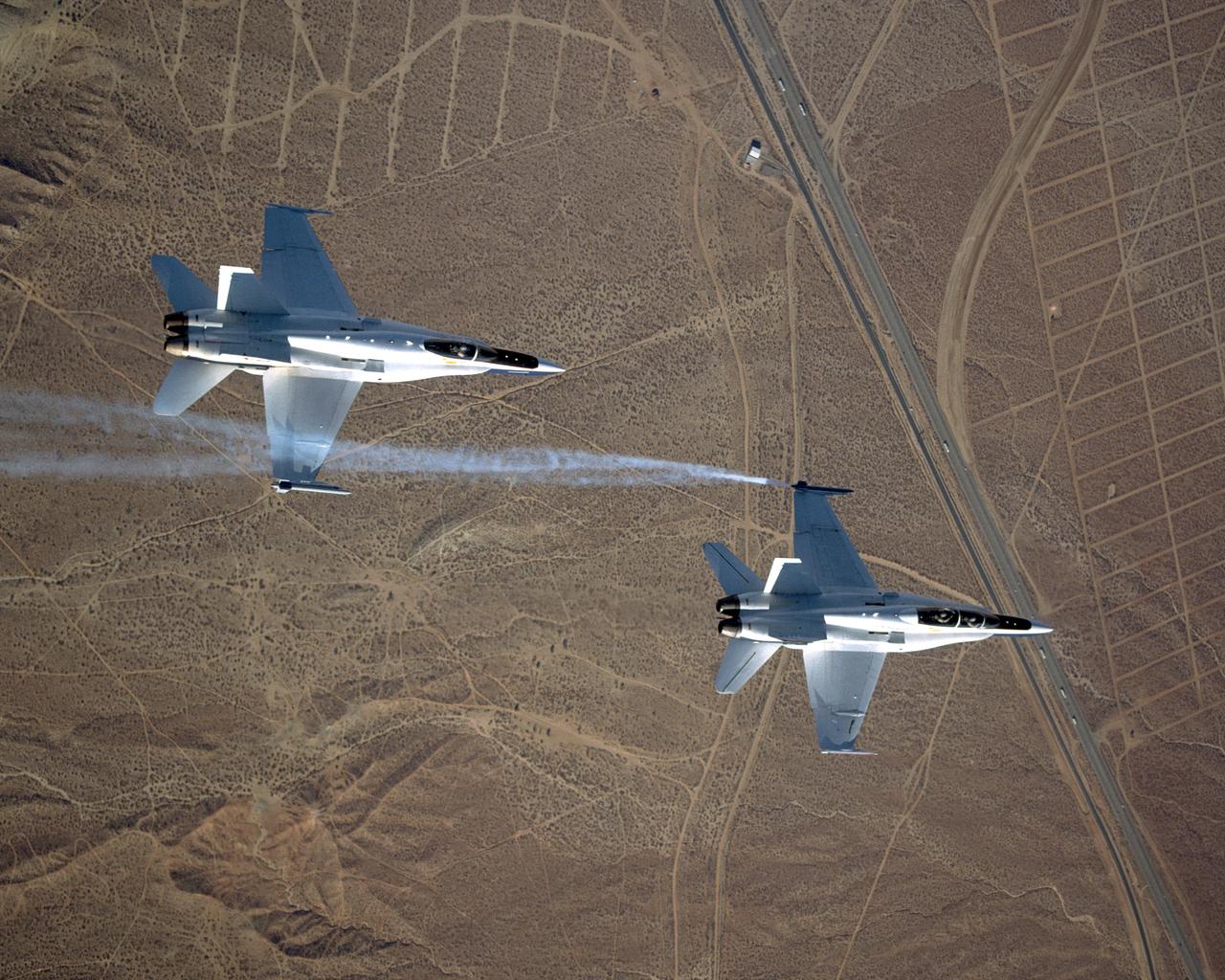 Smoke generators show the twisting paths of wingtip vortices behind two NASA Dryden F/A-18's used in the Autonomous Formation Flight (AFF) program during flight #743.