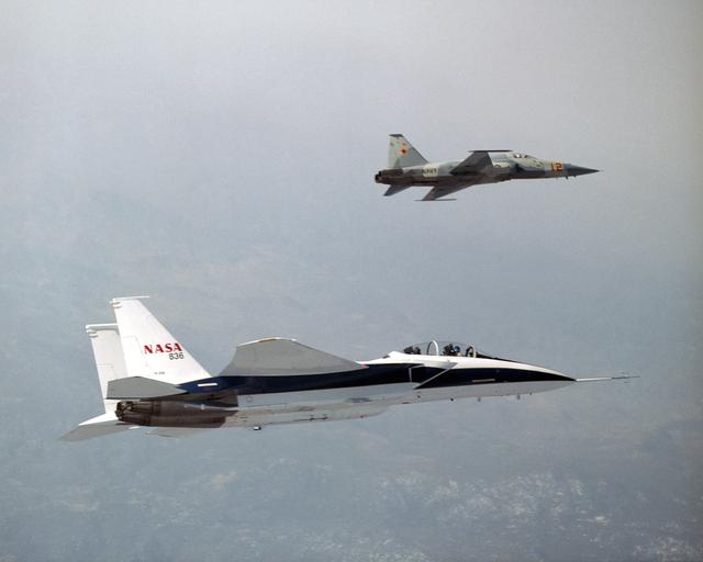 NASA image: NASA's F-15B Research Testbed aircraft flies in the supersonic shock wave of a U.S. Navy F-5E as part of the F-5 Shaped Sonic Boom Demonstration (SSBD) project.