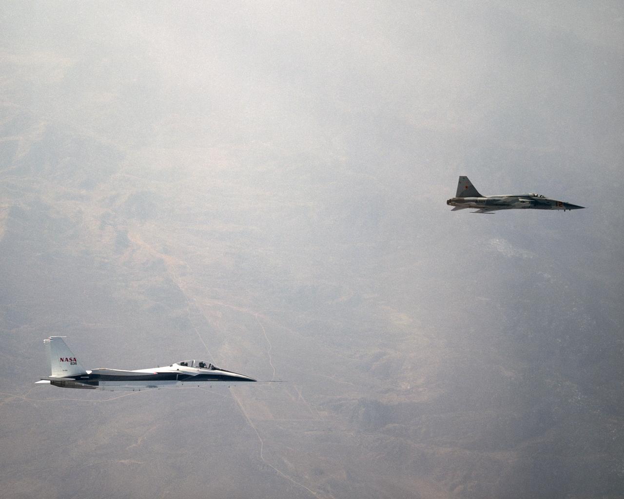 NASA's F-15B Research Testbed aircraft recently flew in the supersonic shock wave of a U.S. Navy F-5E in support of the F-5 Shaped Sonic Boom Demonstration (SSBD) project, part of the Defense Advanced Research Projects Agency's (DARPA) Quiet Supersonic Platform (QSP) program.  The flights originated from the NASA Dryden Flight Research Center at Edwards, California. Four flights were flown in order to measure the F-5E's near-field (close-up) sonic boom signature at Mach 1.4, during which more than 50 shockwave patterns were measured at distances as close as 100 feet below the F-5E.