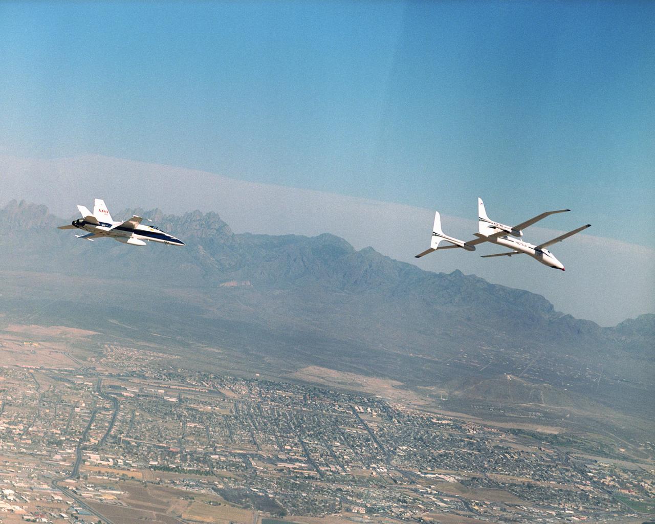 Proteus and an F/A-18 Hornet from NASA's Dryden Flight Research Center are seen here in flight over Las Cruces, New Mexico.