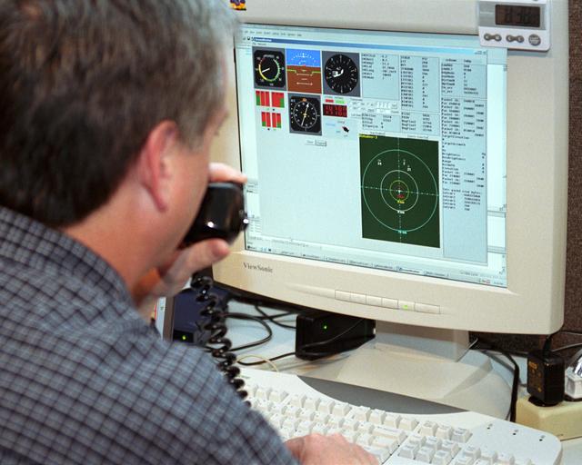 Scaled Composites' Doug Shane examines the screen of his ground control station during tests in New Mexico. Shane used this configuration as the ground control station to remotely pilot the Proteus aircraft during a NASA sponsored series of tests.