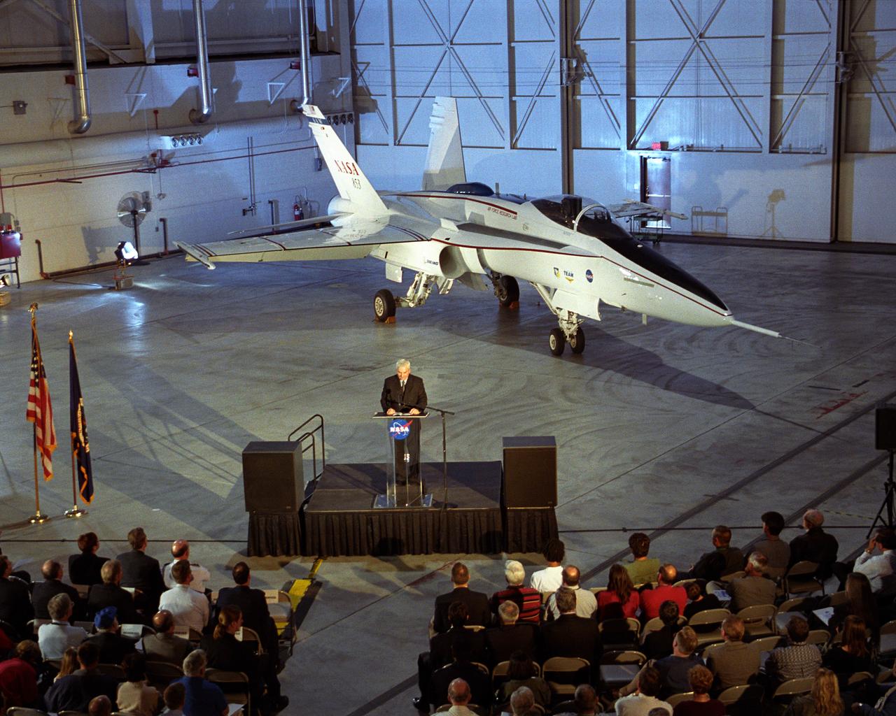 With the modified F/A-18 showcased behind him, Kevin Petersen, director of NASA Dryden Flight Research Center, addressed the audience attending the rollout ceremonies for the Active Aeroelastic Wing flight research project.