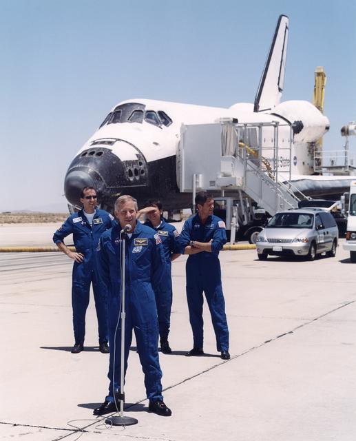 STS-111 commander Ken Cockrell greets dignitaries and recovery technicians on the runway at Edwards Air Force Base following the landing of the space shuttle Endeavour on June 19, 2002. Behind Cockrell are (from left) mission specialists Philippe Perrin a