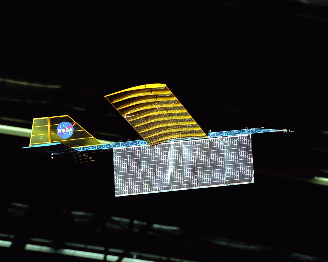 An experimental radio-controlled model aircraft is seen here in flight, powered only by light energy beamed to it by a spotlight.
