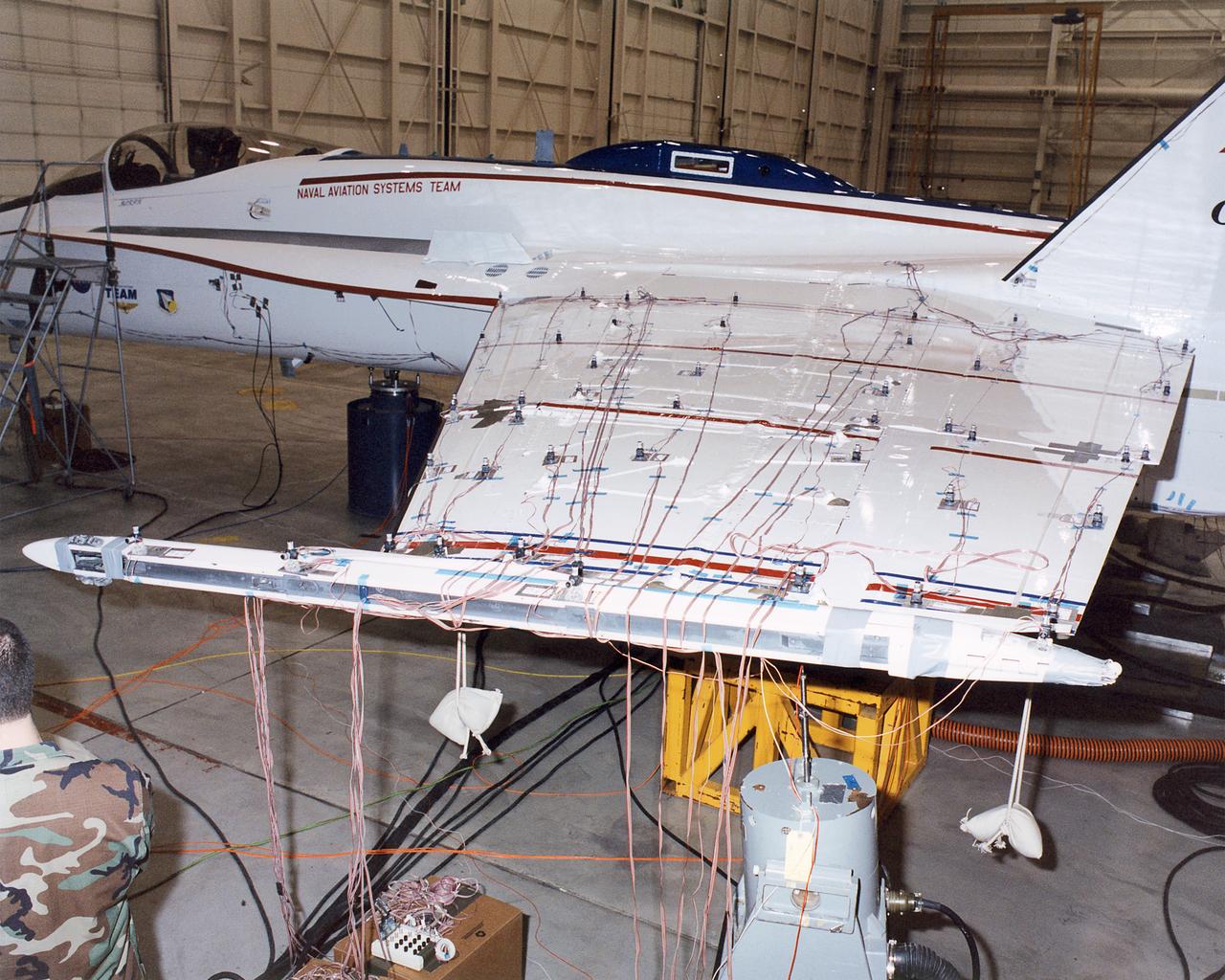 The upper wing surfaces of the Active Aeroelastic Wing F/A-18 test aircraft are covered with accelerometers and other sensors during ground vibration tests at NASA Dryden Flight Research Center.