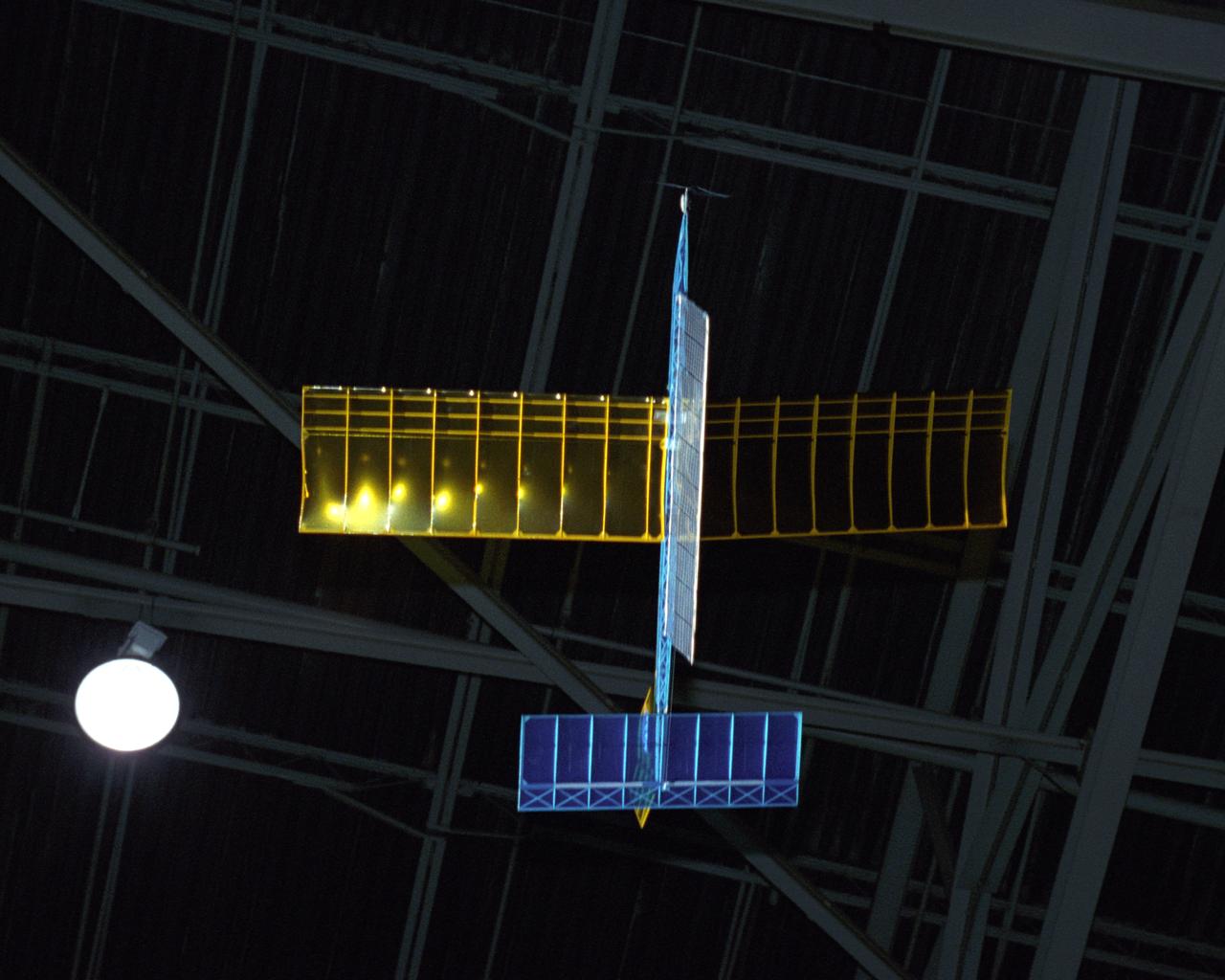 An experimental radio-controlled model aircraft is seen here in flight powered only by light energy beamed to it by a spotlight.