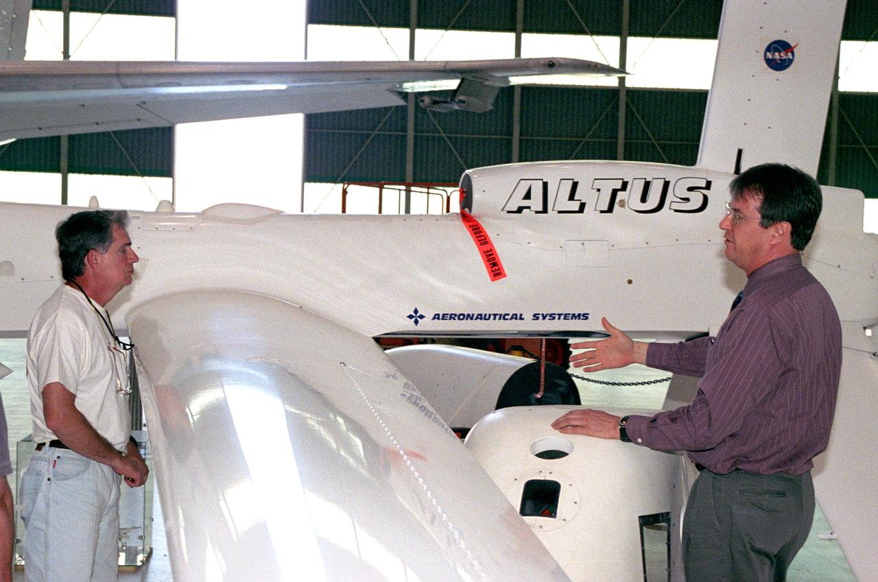 David Bushman, unmanned aerial vehicle (UAV) mission manager in NASA Dryden's Airborne Science Program, explains the capabilities of the Altus UAV to Charles Hudgins of NASA Langley's Chemistry and Dynamics Branch.