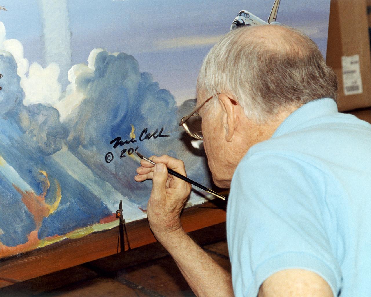 Artist Bob McCall signs the Centennial of Flight Mural in his Paradise Valley, Arizona Studio. The mural was created to celebrate the achievements of Wilbur and Orville Wright and to commemorate a century of powered flight. Many of the epic flights represented in the painting took place in the skies over NASA Dryden Flight Research Center. An equally important goal of this celebration is to encourage the values that have characterized 100 years of aviation history: ingenuity, inventiveness, persistence, creativity and courage. These values hold true not just for pioneers of flight, but also for all pioneers of invention and innovation, and they will remain an important part of America's future.  "Celebrating One Hundred Years of Powered Flight, 1903-2003", documents many significant achievements in aeronautics and space flight from the dawn of powered flight to the present.  Historic aircraft and spacecraft serve as the backdrop, highlighting six figures representing the human element that made these milestones possible. These figures stand, symbolically supported by the words of Wilbur Wright, "It is my belief that flight is possible…" The quote was taken from a letter written to his father on September 3rd, 1900, announcing Wilbur's intention to make "some experiments with a flying machine" at Kitty Hawk, North Carolina.  "This year, Bob is helping us commemorate the Centennial of Flight with a beautiful mural slated for placement in our Dryden Flight Research Center that documents the history of flight from the Wright Flyer to the International Space Station. We should all take note, I think, that in the grand scheme of things, one hundred years is a very short period of time. In that blink of an eye we've gone from Kitty Hawk to Tranquility Base and now look forward to our rovers traversing the surface of Mars. Despite the challenges we face, the future we envision, like the future depicted in the artwork of Bob McCall, is a future of boundless possibility. " 