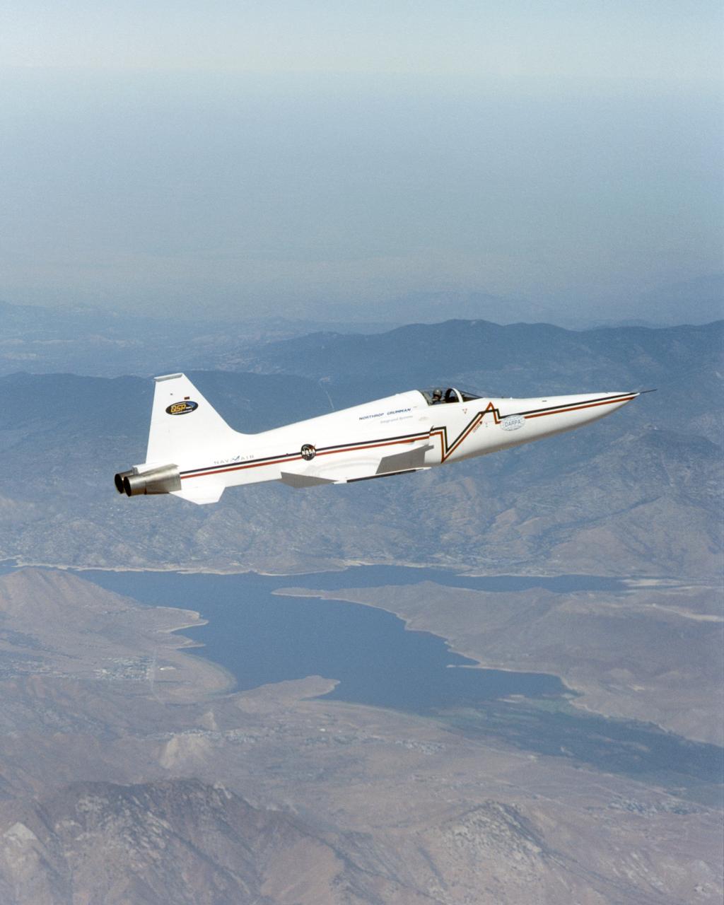 Northrop Grumman Corporation's modified U.S. Navy F-5E Shaped Sonic Boom Demonstration (SSBD) aircraft flies over Lake Isabella, California on Aug. 4, 2003. NASA Dryden provided range, air and ground data-gathering support for the SSBD project, which is part of DARPA's Quiet Supersonic Platform (QSP) program.
