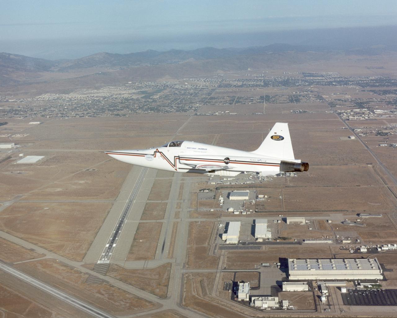 Northrop Grumman Corporation's modified U.S. Navy F-5E Shaped Sonic Boom Demonstration (SSBD) aircraft flies over the company's Palmdale, California facilities on Aug. 2, 2003. NASA Dryden provided range, air and ground data-gathering support for the SSBD project, which is part of DARPA's Quiet Supersonic Platform (QSP) program.