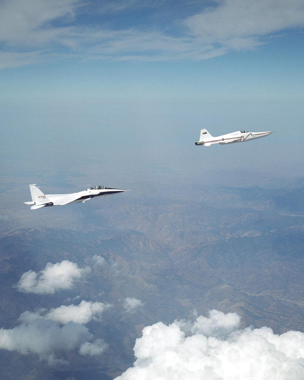 NASA's F-15B research testbed jet from NASA's Dryden Flight Research Center flew in the supersonic shockwave of a Northrop Grumman Corp. modified U.S. Navy F-5E jet in support of the Shaped Sonic Boom Demonstration (SSBD) project, which is part of the DARPA's Quiet Supersonic Platform (QSP) program.  The project is an effort to lessen sonic booms.  During the recent demonstration, the F-15B flew behind the modified F-5E sonic boom demonstrator aircraft in order to measure the aircraft's sonic boom characteristics.  Flying behind and below the F-5E, and using its specially-instrumented nose boom, the F-15B recorded many shockwave patterns from the F-5E at various distances and orientations from the aircraft.