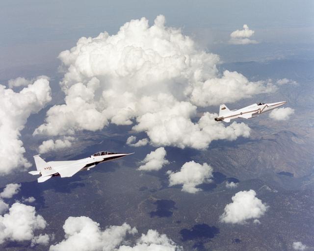 NASA's F-15B from the Dryden Flight Research Center flew in the supersonic shockwave of a modified U.S. Navy F-5E jet in support of the Shaped Sonic Boom Demonstration (SSBD) project. On Aug. 27, 2003, the F-5 SSBD aircraft demonstrated a method to reduce