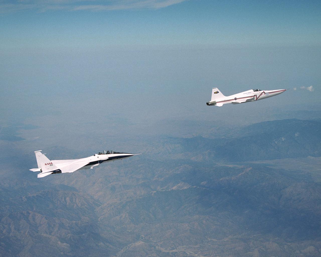 NASA's F-15B research testbed jet from the NASA Dryden Flight Research Center flew in the supersonic shockwave of a Northrop Grumman Corp. modified F-5E in support of the Shaped Sonic Boom Demonstration (SSBD) project, which is part of the DARPA's Quiet Supersonic Platform (QSP) program.