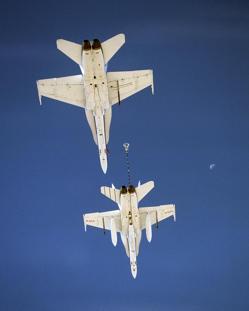 NASA Dryden's Automated Aerial Refueling (AAR) project evaluated the capability of an F/A-18A aircraft as an in-flight refueling tanker with the objective of developing analytical models for an automated aerial refueling system for unmanned air vehicles. The F/A-18 "tanker" aircraft (No. 847) underwent flight test envelope expansion with an aerodynamic pod containing air-refueling equipment carried beneath the fuselage. The second aircraft flew as the receiver aircraft during the study to assess the free-stream hose and drogue dynamics on the F/A-18A.