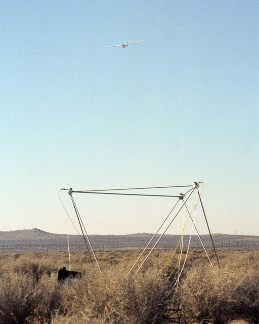 NASA image: A Blanik L-23 glider carrying a microphone and a pressure transducer flies near a BADS sensor following flight under the path of the F-5E SSBE aircraft