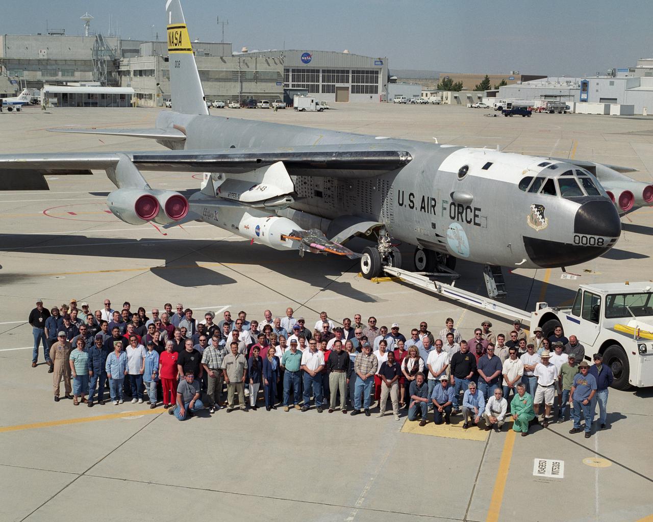 The Hyper-X X-43A project team in front of NASA's B-52B launch aircraft with the Pegasus booster and X-43A vehicle attached.
