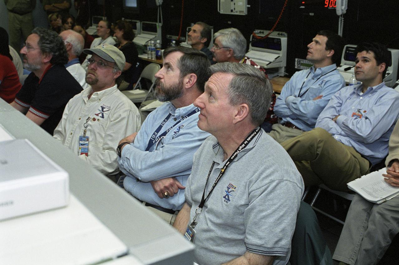 NASA personnel in a control room during the successful second flight of the X-43A aircraft. front row, left to right: Randy Voland, LaRC Propulsion; Craig Christy, Boeing Systems; Dave Reubush, NASA Hyper-X Deputy Program Manager; and Vince Rausch, NASA Hyper-X Program Manager. back row, left to right: Bill Talley, DCI/consultant; Pat Stoliker, DFRC Director (Acting) of Research Engineering; John Martin, LaRC G&C; and Dave Bose, AMA/Controls.