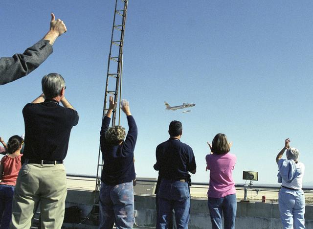 NASA image: Employees atop DFRC's main building celebrate the return flyby of the B-52B aircraft after it launched the second X-43A aircraft on its successful flight