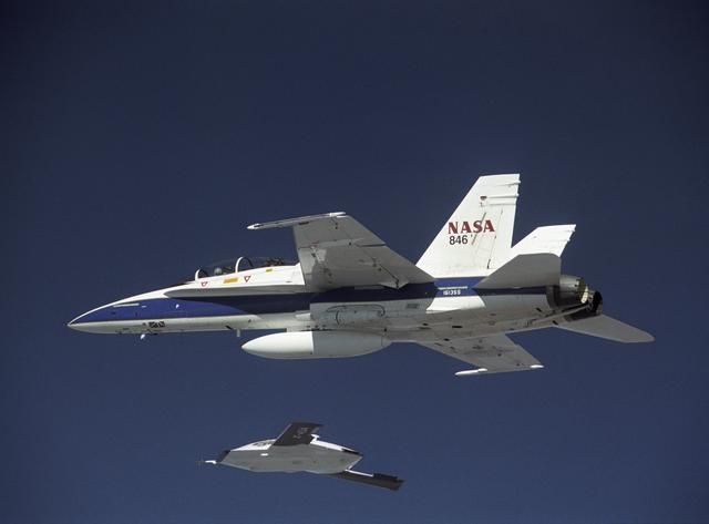 NASA image: X-45A in flight with F-18 #846 chase aircraft, during first GPS-guided weapon demonstration flight