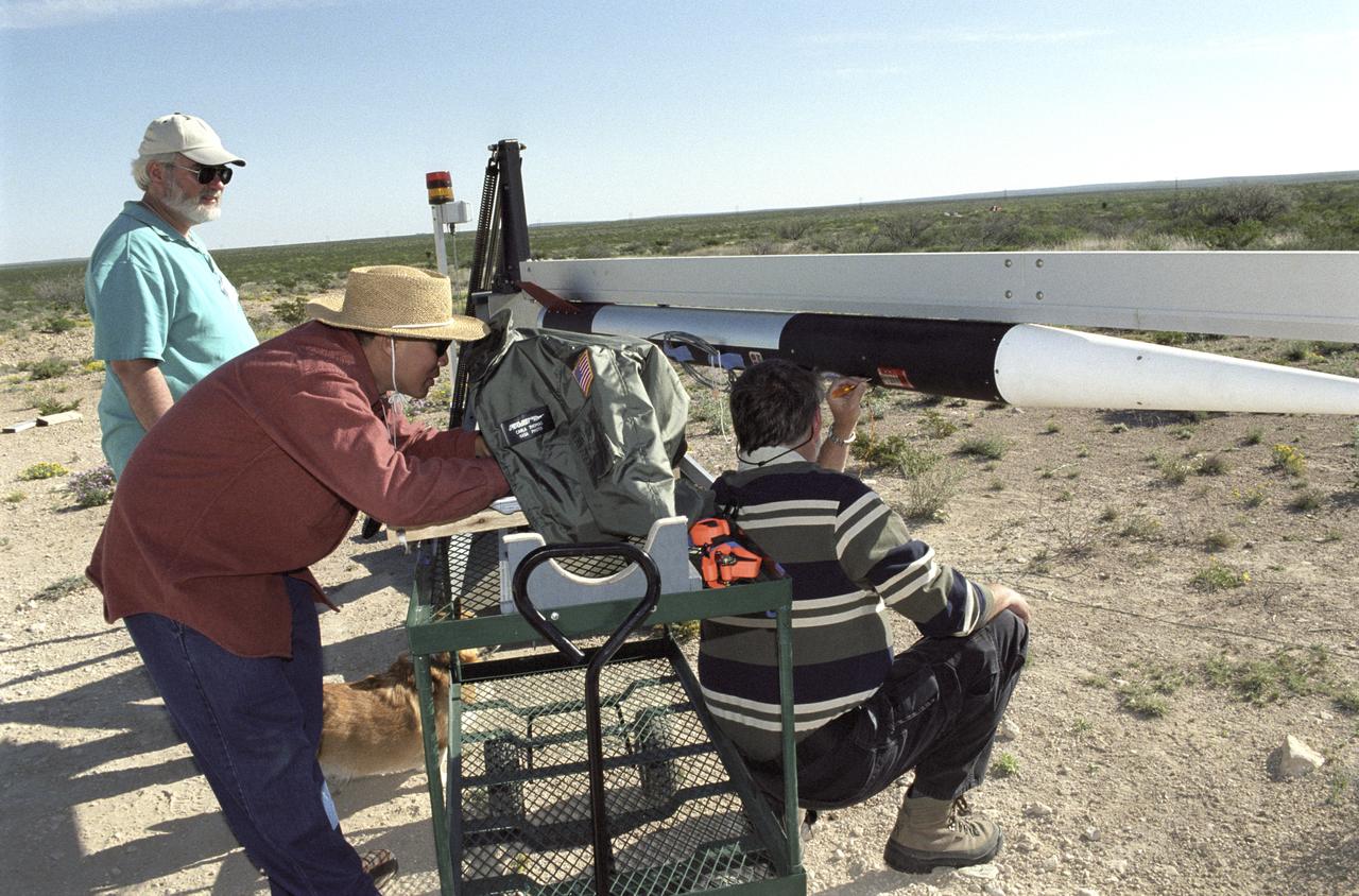 Chuck Rogers, Trong Bui, and Scott Bartel make preflight checks on the second of two aerospike research rockets on March 31, 2004.