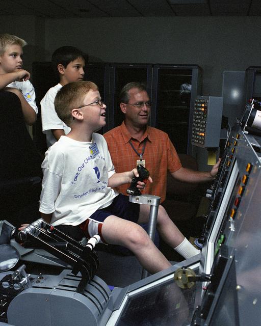 Eddie Patterson enjoyed "flying" a C-17 simulator during Take Your Children to Work Day June 22 while Dryden engineer Ken Norlin and other students look on
