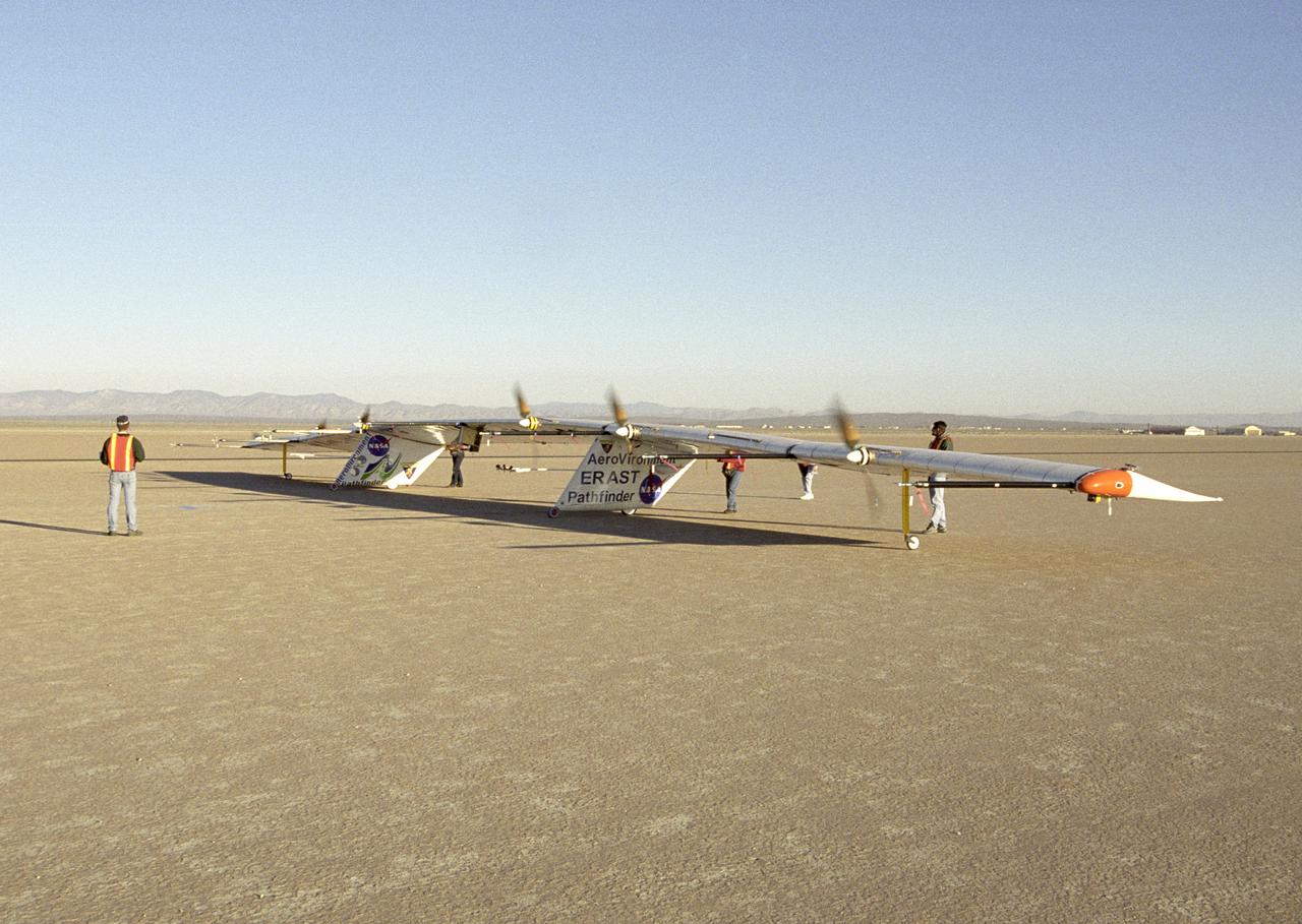 AeroVironment ground crew check out the operation of the Pathfinder-Plus solar aircraft's electric motors during combined systems tests on Rogers Dry Lake.