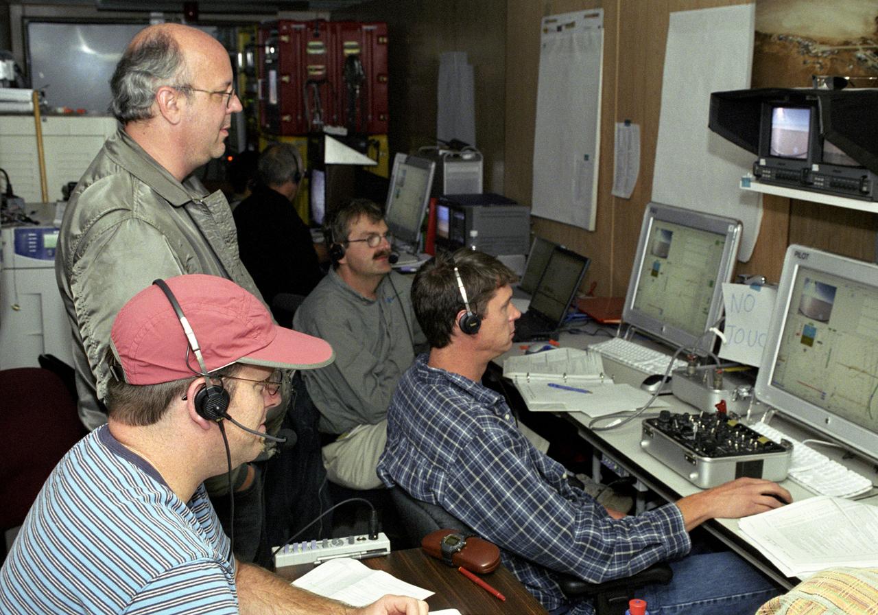 AeroVironment's test director Jim Daley, backup pilot Rik Meininger, stability and controls engineer Derek Lisoski and pilot Wyatt Sadler (clockwise from bottom left) closely monitor systems testing of the Pathfinder-Plus solar aircraft from the control station.