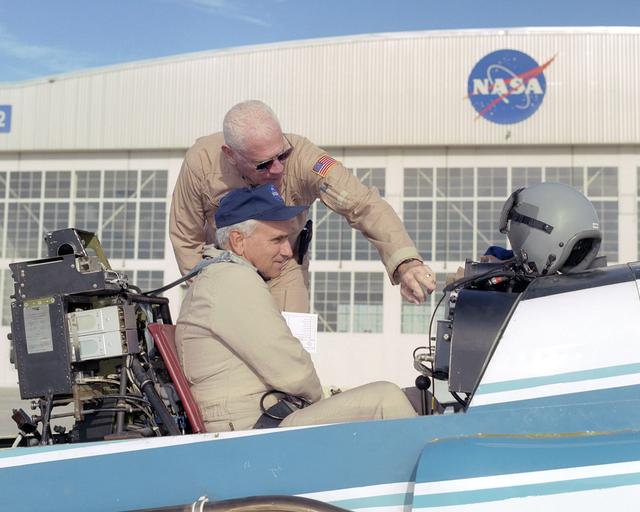 NASA image: NASA pilot Ed Lewis (rear) briefs NASA test pilot Dick Ewers on the flight instruments of NASA's YO-3A acoustics research aircraft prior to a checkout flight.