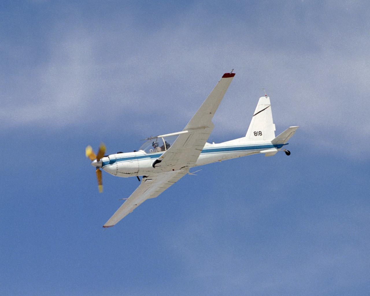 The slow-speed wooden propeller and long wings are evident as NASA's YO-3A acoustics research aircraft performs a low-level flyover at Edwards Air Force Base.