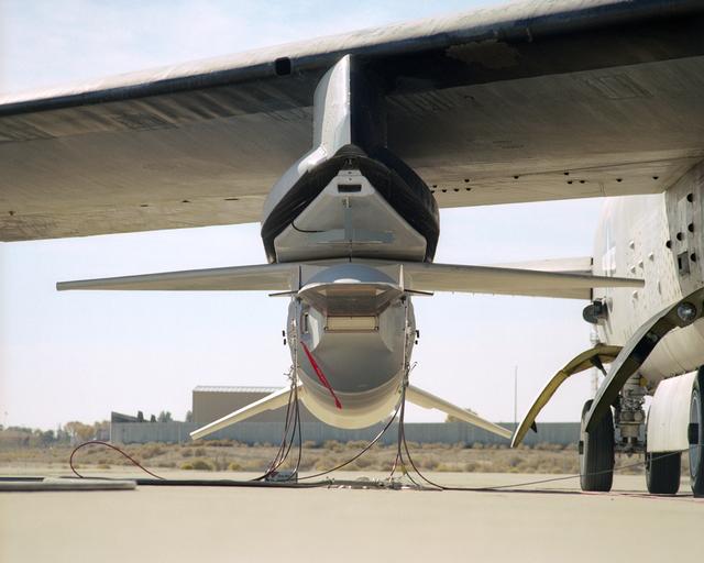 NASA image: The small size of the X-43A scramjet is evident in this nose-on view while mounted to its modified Pegasus booster under the wing of NASA's B-52B mothership
