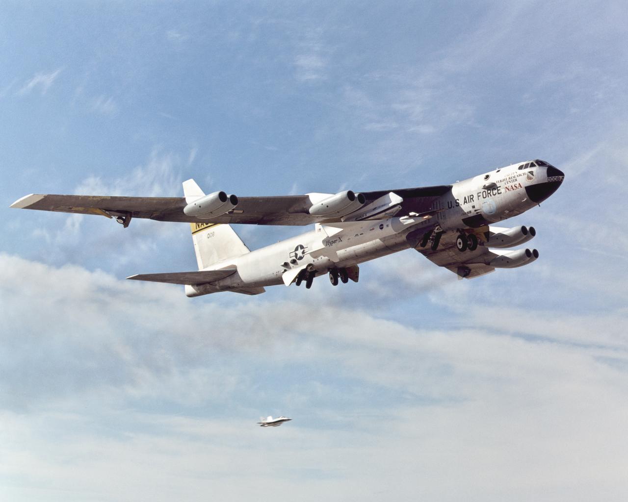 With the X-43A and its booster rocket tucked under its right wing, NASA's venerable B-52B mothership climbs out after takeoff on its final research mission.