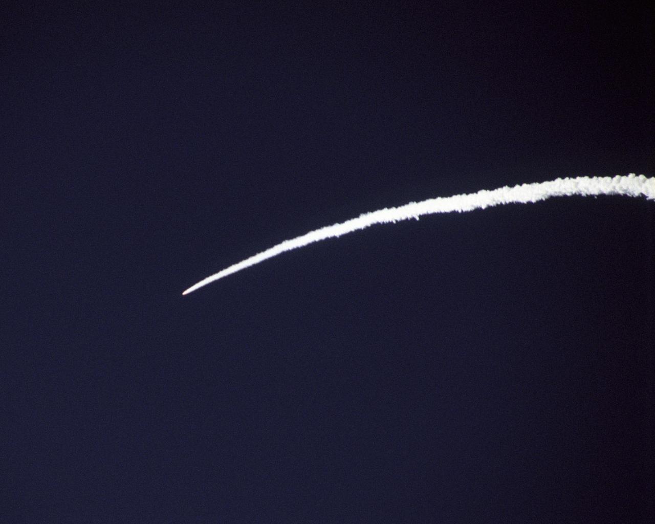 The Pegasus rocket that powered NASA's X-43A scramjet to almost Mach 10 test conditions leaves a bright arc in the Pacific sky during the boost phase.