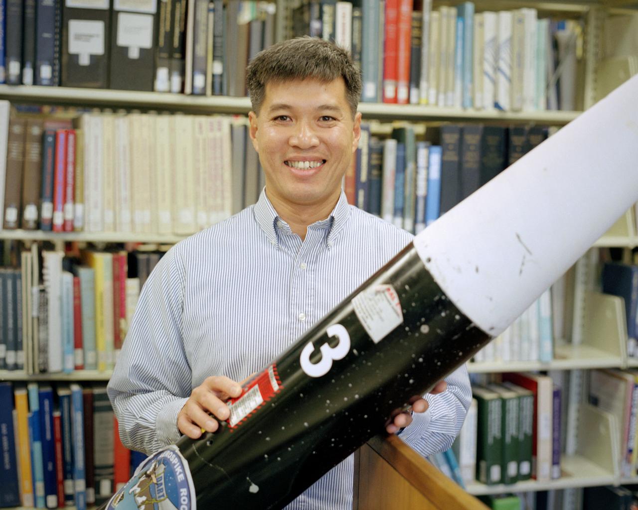 Trong Bui, NASA Dryden's principal investigator for the aerospike rocket tests, holds the first of two 10-ft. long rockets that were flown at speeds up to Mach 1.5, the first known supersonic tests of rockets with aerospike nozzles. The goals of the flight research project were to obtain aerospike rocket nozzle performance data in flight and to investigate the effects of transonic flow and transient flight conditions on aerospike nozzle performance.