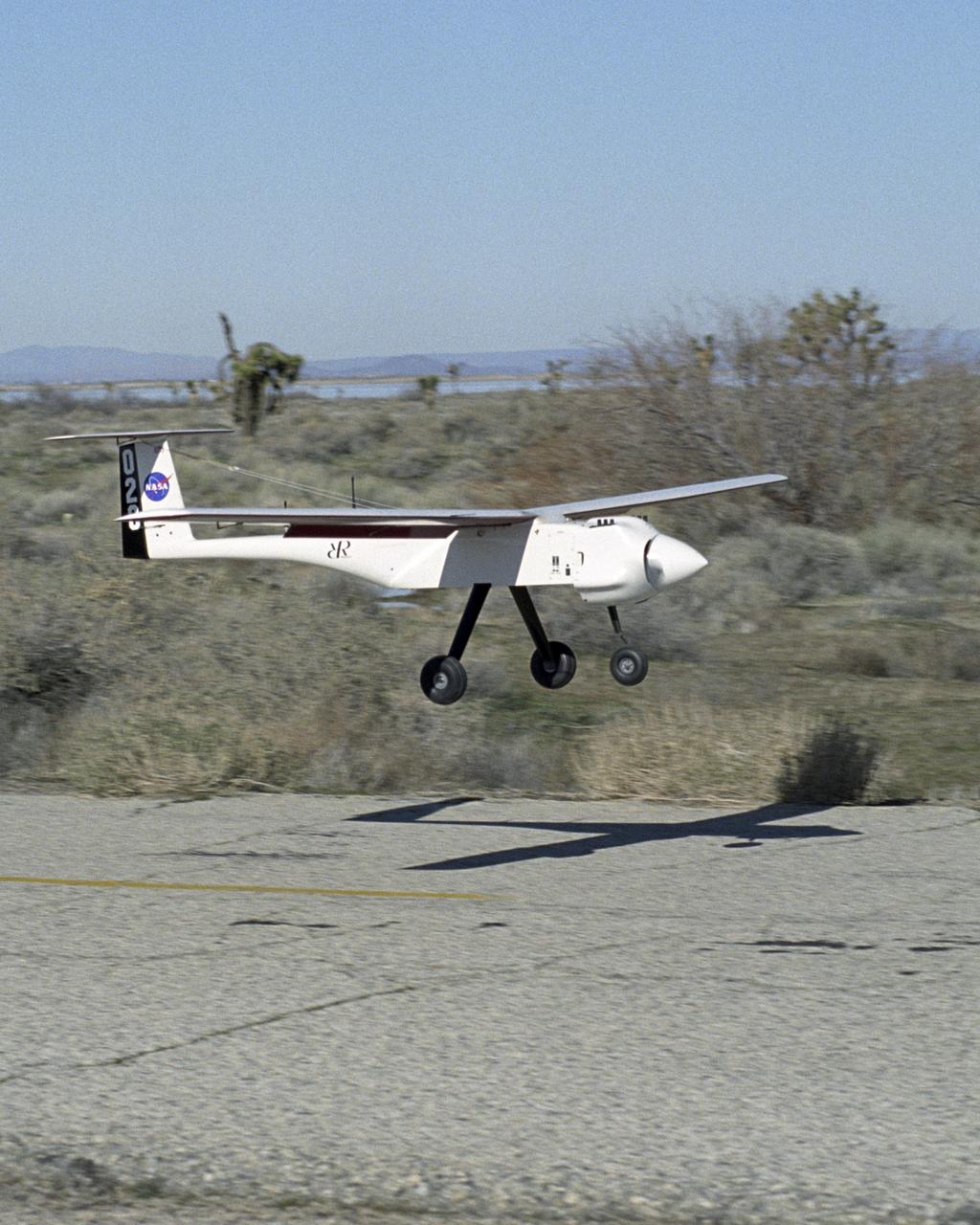 One of two small APV-3 aircraft flown in the joint Ames-Dryden Networked UAV Teaming Experiment flares for landing on a roadway on a remote area of Edwards AFB.