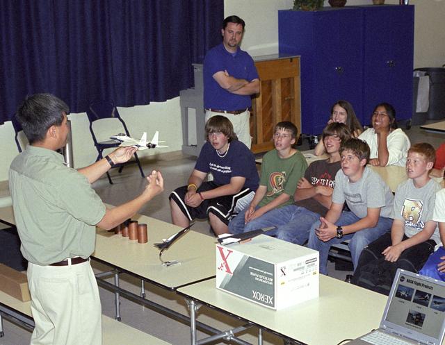 NASA image: NASA Dryden aerospace engineer Trong Bui explains the dynamics of flight to a group of Edwards Middle School students during a recent Career Day presentation.