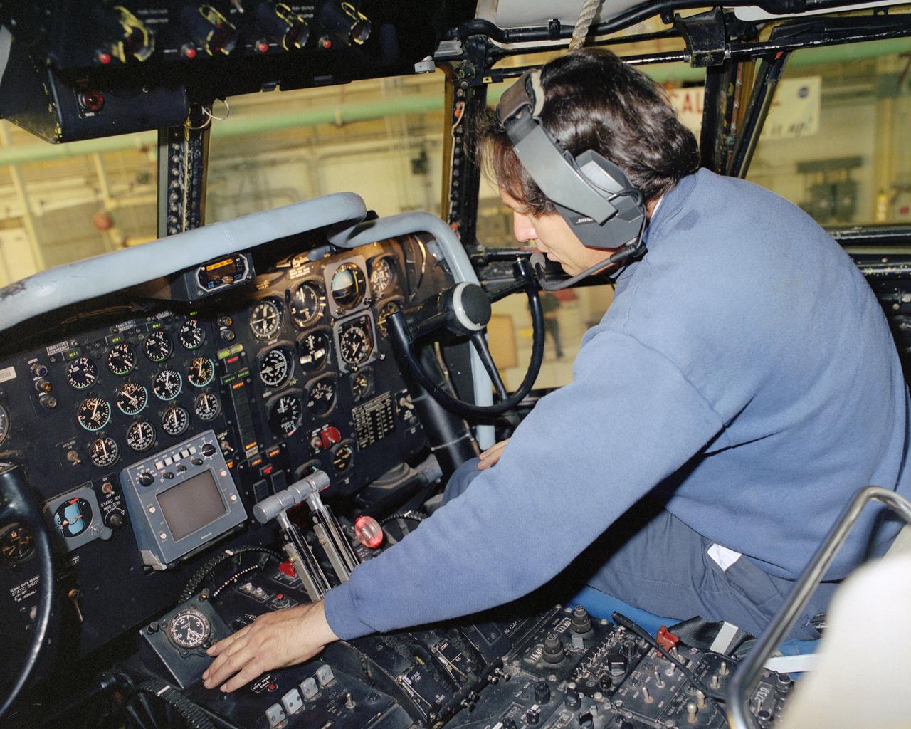 Assistant crew chief David Wyckoff checks out operation of the Super Guppy's new landing gear from the flight deck after changeout is complete.