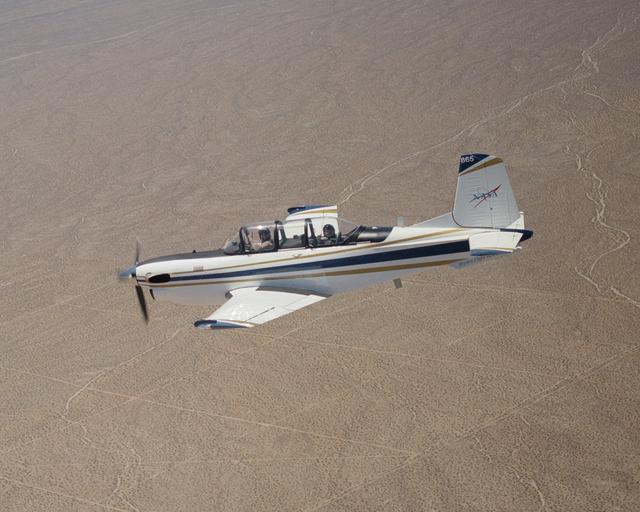 NASA image: A Beech T-34C flown by NASA Dryden Flight Research Center for mission support descends over the Southern California desert near Edwards Air Force Base