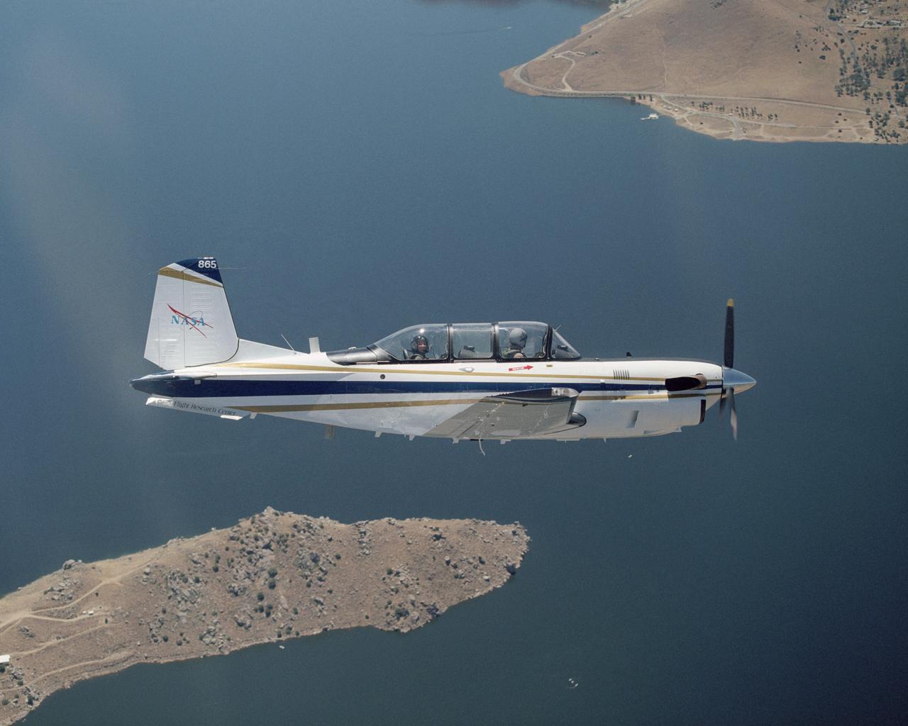 A Beech T-34C aircraft used by NASA Dryden Flight Research Center for mission support banks over Lake Isabella in Kern County during a recent flight.
