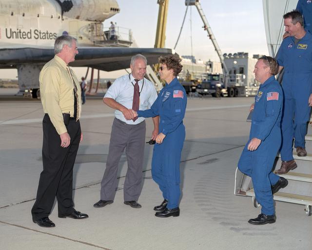 NASA image: NASA DFRC Deputy Director Steven Schmidt and DFRC Shuttle Program Manager Joe D'Agostino greet Commander Eileen Collins and the crew of STS-114