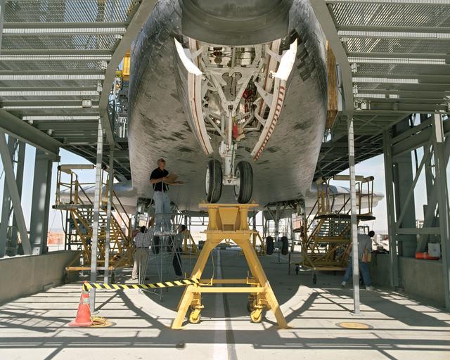 NASA image: The Space Shuttle Discovery receives post-flight servicing in the Mate-Demate Device (MDD) at NASA's Dryden Flight Research Center, Edwards, California