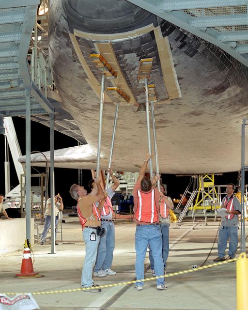 NASA image: Closing the landing gear doors is one of the final servicing steps before lifting the Space Shuttle Discovery and mating it to NASA's 747 can begin