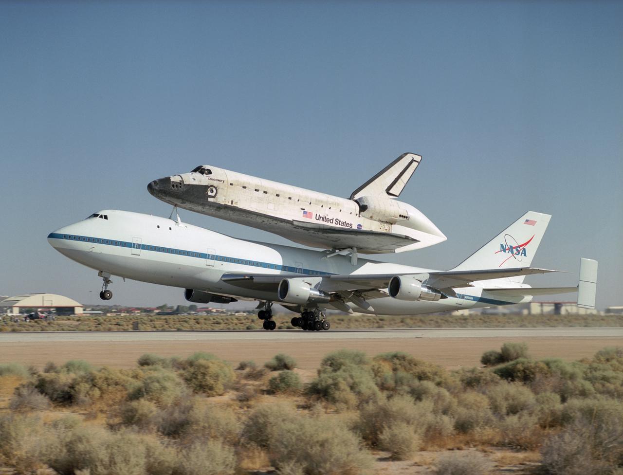 NASA's modified Boeing 747 Shuttle Carrier Aircraft with the Space Shuttle Discovery on top lifts off from Edwards Air Force Base to begin its ferry flight back to the Kennedy Space Center in Florida. The cross-country journey will take two days, with stops at several intermediate points for refueling. Space Shuttle Discovery landed safely at NASA's Dryden Flight Research Center at Edwards Air Force Base in California at 5:11:22 a.m. PDT, August 9, 2005, following the very successful 14-day STS-114 return to flight mission.  During their two weeks in space, Commander Eileen Collins and her six crewmates tested out new safety procedures and delivered supplies and equipment the International Space Station.  Discovery spent two weeks in space, where the crew demonstrated new methods to inspect and repair the Shuttle in orbit. The crew also delivered supplies, outfitted and performed maintenance on the International Space Station. A number of these tasks were conducted during three spacewalks.  In an unprecedented event, spacewalkers were called upon to remove protruding gap fillers from the heat shield on Discovery's underbelly. In other spacewalk activities, astronauts installed an external platform onto the Station's Quest Airlock and replaced one of the orbital outpost's Control Moment Gyroscopes.  Inside the Station, the STS-114 crew conducted joint operations with the Expedition 11 crew. They unloaded fresh supplies from the Shuttle and the Raffaello Multi-Purpose Logistics Module. Before Discovery undocked, the crews filled Raffeallo with unneeded items and returned to Shuttle payload bay.  Discovery launched on July 26 and spent almost 14 days on orbit.