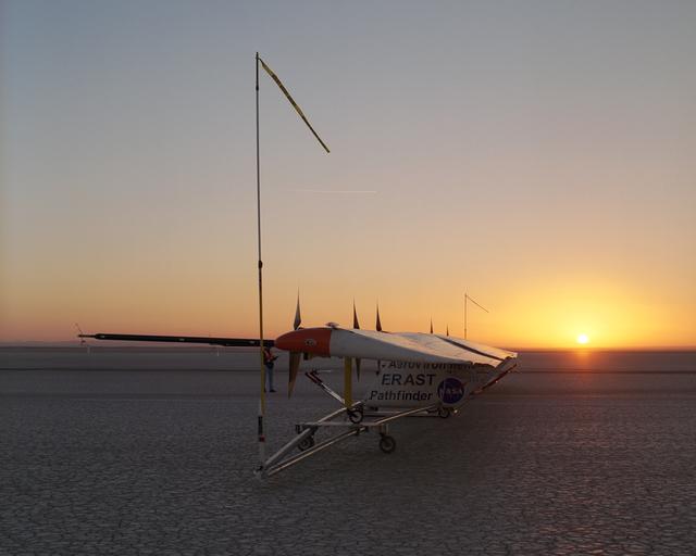 NASA image: As the rising sun dawns over the parched bed of Rogers Dry Lake, AeroVironment's solar-electric Pathfinder-Plus awaits takeoff on its final research flight.