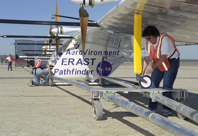 NASA image: AeroVironment technicians prepare to remove the Pathfinder-Plus solar aircraft from its ground dolly before a turbulence measurement flight.