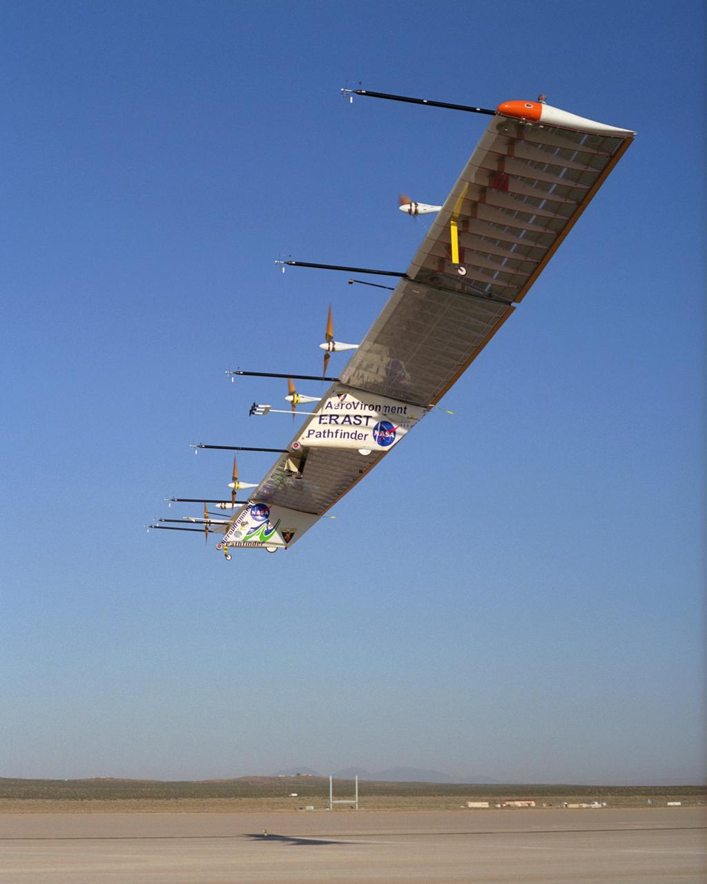 The Atmospheric Turbulence Measurement System booms extend forward from the Pathfinder-Plus solar wing as it soars over Rogers Dry Lake on its final flight.