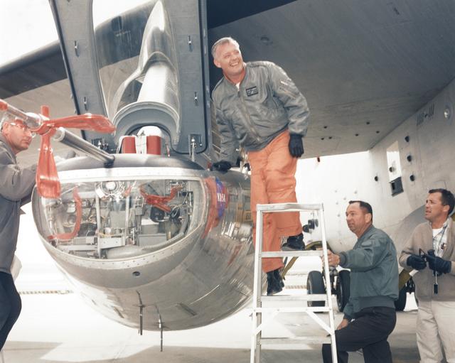NASA image: Jay L. King, Joseph D. Huxman, and Orion D. Billeter Assist Pilot Milt Thompson into the M2-F2 Attached to B-52 Mothership
