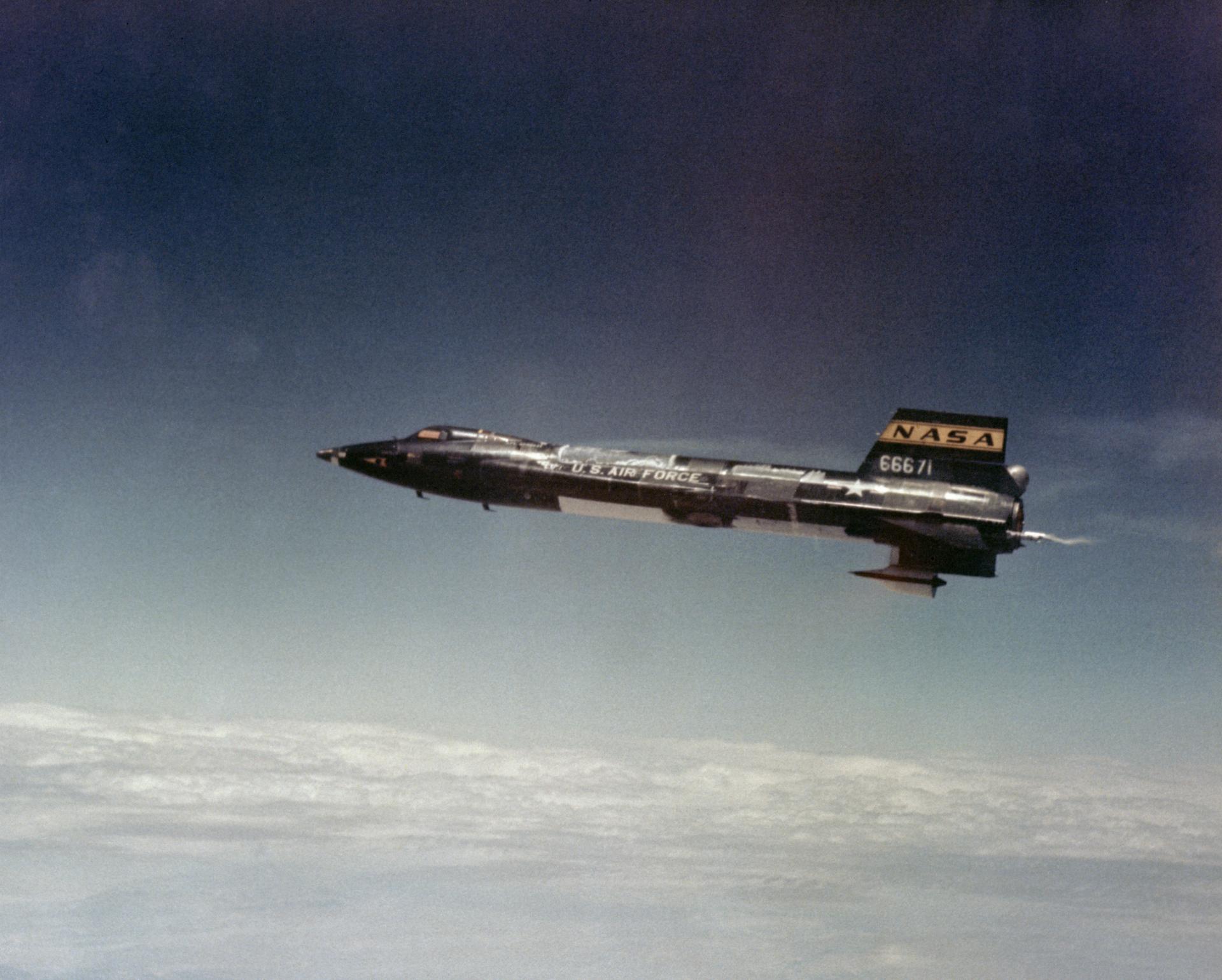 An aircraft in flight above the clouds.