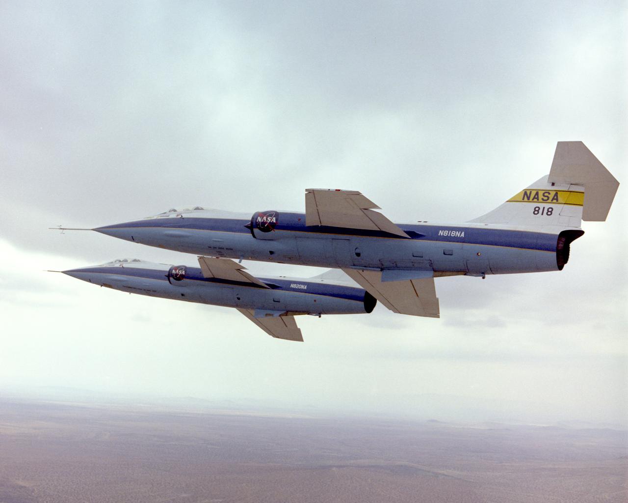 F-104A #818 flown by Einar Enevoldson and F-104A #820 flown by Gary Krier in formation over the Mojave Desert. 4/11/75 NASA DFRC EC76-5140 