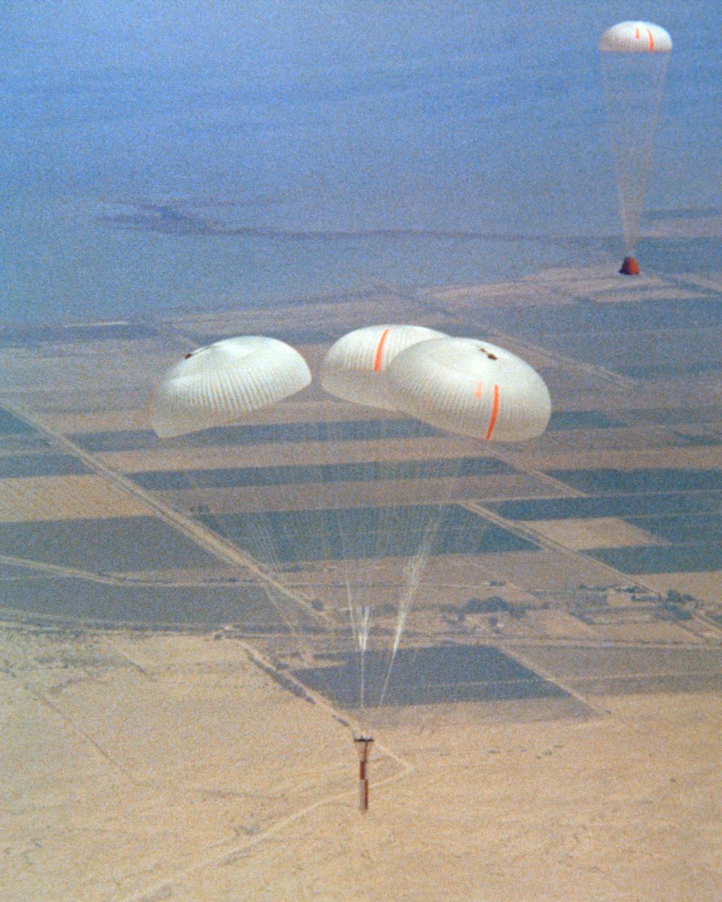 Space Shuttle Solid Rocket Booster Drop Test Vehicle (SRB-DTV) with chutes open after release from NB-52B
