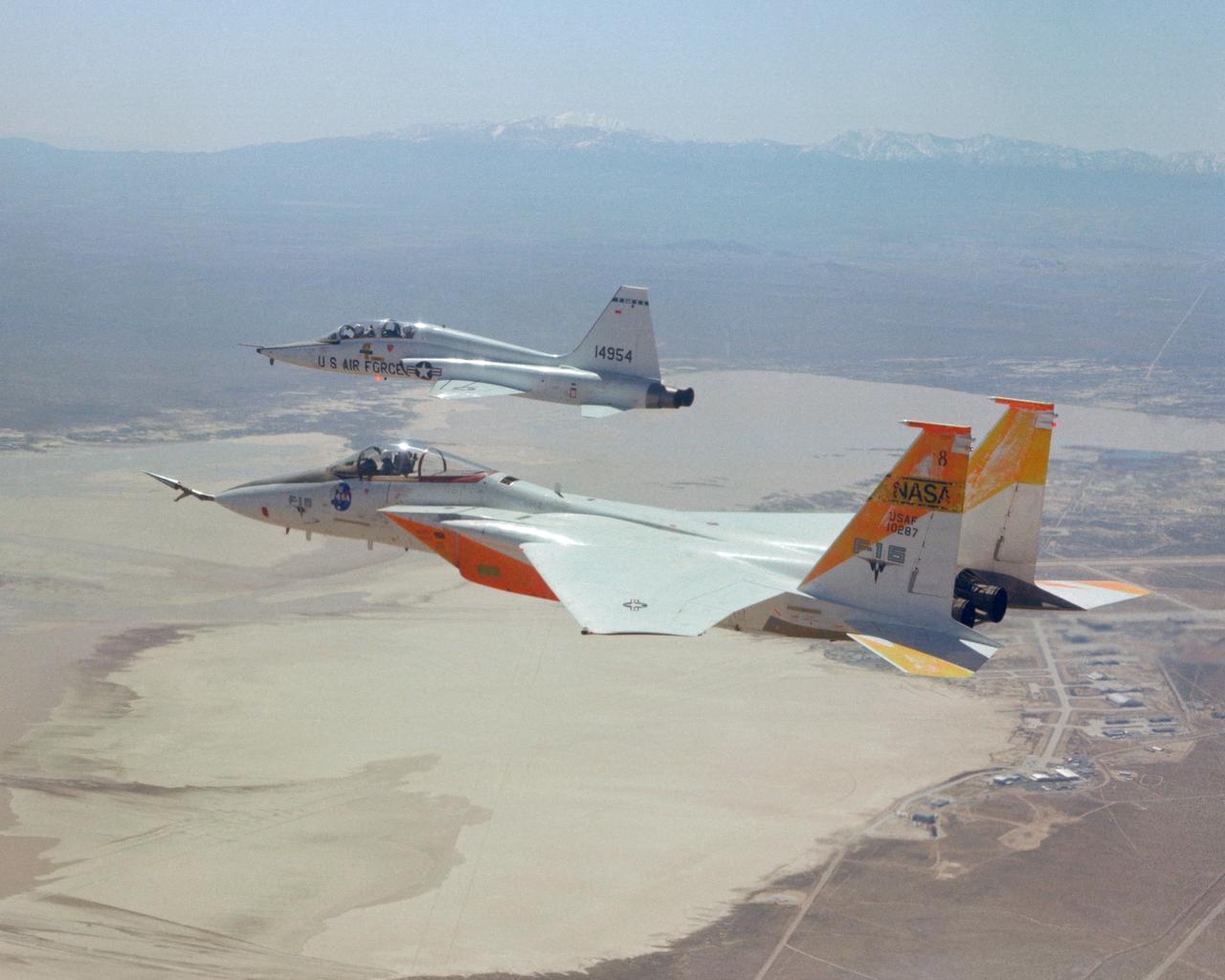 An in-flight photo of the NASA F-15A used to carry a 10 degree cone to collect aerodynamic data to calibrate the data from wind tunnels. Acting as chase for the flight was a NASA T-38 aircraft.